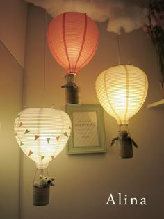 three chinese lanterns are hanging from the ceiling