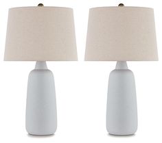 two white ceramic lamps with beige linen shades on each lamp and one is turned off