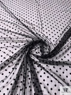 black and white photograph of polka dot fabric