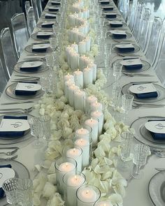 a long table with candles and flowers on it