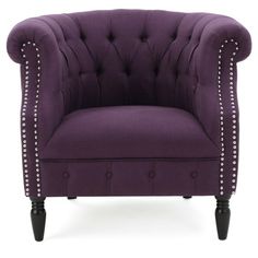 an upholstered purple chair with studding on the arms and back, against a white background