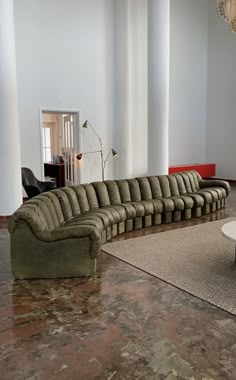 a long couch sitting in the middle of a living room