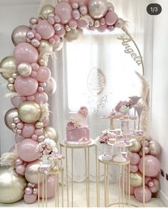 a pink and gold birthday party with balloons, cake and desserts on the table