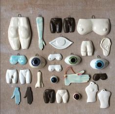 many different types of ceramic items on a table top with one eye and the other hand