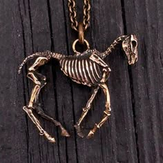 "The hungry horse has been on my workbench for well over a year. A completely 3D horse skeleton made of solid bronze. Traditionally a horses height is measured in hands, this little guy is measured in fingers, he stands 1-1/2 pinkies high at the shoulder which converts to one inch tall and 1-1/4\" from his nose to the tip of his tail.... bone. I got lucky when positioning the jump ring as he balanced perfectly on the very first try(see the third picture). Bronze is extremely malleable making thi Skeleton Horse, Horse Skeleton, Tail Bone, Equine Jewelry, Skeleton Jewelry, 3d Horse, Skeleton Necklace, Equestrian Art, Bone Jewelry