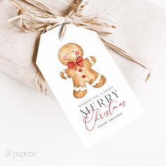 a christmas card with a ginger on it next to a wrapped present box and twine