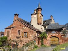 an old brick building with a clock tower on the top of it's roof