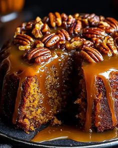 a bundt cake with pecans and caramel drizzled on top