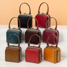 six different colored purses sitting on top of each other