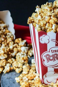 a close up of popcorn in a paper cup