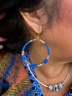 Hoop Earrings with vibrant blue and gold colored beads. Gauze Clothing, Dress With Shawl, Linen Jackets, Flip Flop Slippers, Judy Blue Jeans, Beaded Hoop Earrings, Slipper Socks, Vibrant Blue, Cotton Hoodie