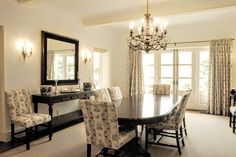 a dining room table with chairs and a chandelier