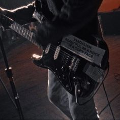 a man is playing an electric guitar on stage