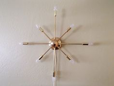 a clock that is on the wall with some lights attached to it's sides