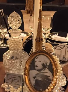 a table topped with glass vases and pictures