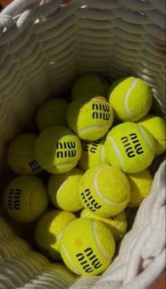 a bag full of tennis balls sitting on top of a table