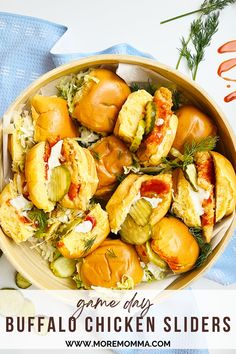 a bowl filled with different types of sliders on top of a blue towel next to carrots