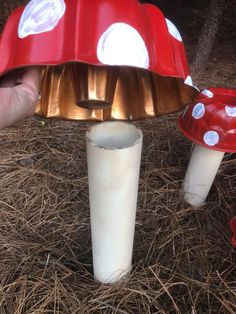 a mushroom shaped candle holder in the shape of a mushroom is being held by someone's hand