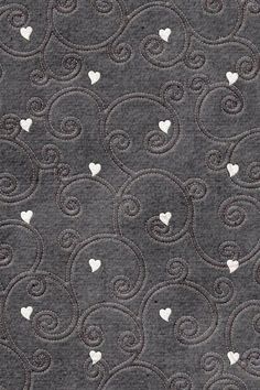 the fabric has hearts on it and is grey with white swirls in the middle