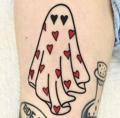 a woman's leg with a tattoo on it that has hearts in the shape of a ghost