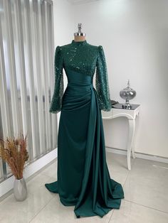 It is a lined, draped dress.  It is made of 100% satin and beaded tulle fabric.  It is a lapel dress.  It is 152 cm long. Fitted Long Sleeve Embellished Abaya, Party Floor-length Fitted Abaya, Fitted Floor-length Party Abaya, Floor-length Fitted Abaya For Party, Formal Fitted Long Abaya, Elegant Sequined Abaya For Party, Elegant Sequined Evening Abaya, Elegant Abaya With Sequins For Party, Evening Embellished Fitted Abaya