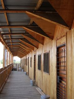 a long wooden walkway lined with windows and shutters