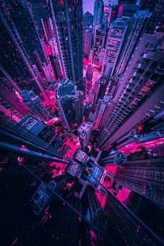 an aerial view of the city at night with bright lights and skyscrapers in the background