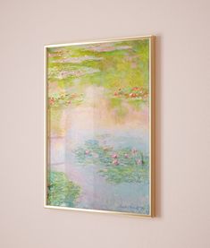 a painting hanging on the wall next to a vase with water lilies in it