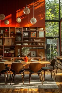 the dining room table is surrounded by wooden chairs and shelves with hanging glass globes