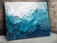 an abstract painting with blue and white colors on the ocean waves, created using acrylic paint