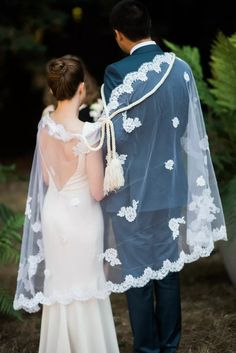 the bride and groom are dressed in their wedding attire