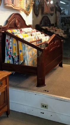 an old fashioned wooden bed in a store