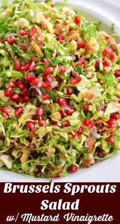 brussels sprouts salad with pomegranate and walnuts in a white bowl