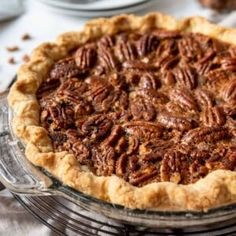 a pecan pie sitting on top of a glass plate