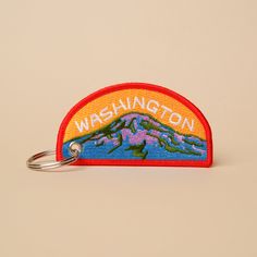 3.5" width x 1.731" height Double-sided embroidered keychain with a key ring. Patch Keychain, Keychain Embroidery, Thesis Ideas, Teacher Portfolio, Brand Merchandise, Mt Rainier, Cotton Labels, Keychain Design, Key Fobs