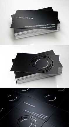 some black and white business cards are stacked on top of each other in different positions