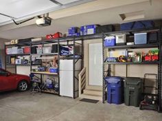 a car is parked in the garage next to shelves with various items on top of them