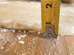 a measuring tape is on top of some dough