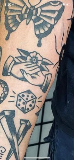 a man with tattoos on his arm and some dices in front of him,