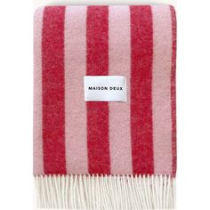 a red and white striped blanket with the name maison deux written on it,