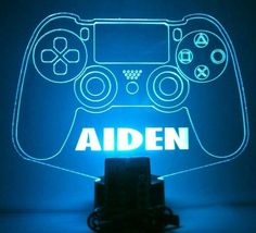 an illuminated video game controller with the word adin on it's back side