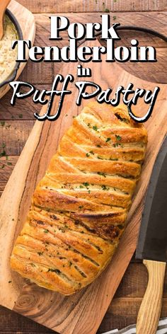 pork tenderion in puff pastry on a cutting board next to a knife and bowl