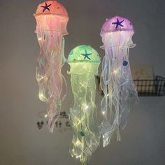 three jellyfish lights hanging from the ceiling