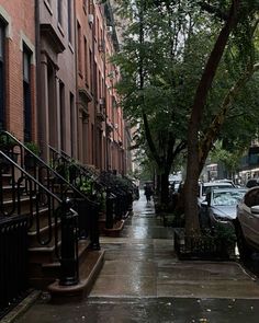 an empty sidewalk with cars parked on it