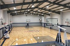 an indoor basketball court is shown in the middle of a gym with hard wood flooring