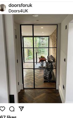 an open door leading to a gym room with treadmills and exercise equipment on the floor