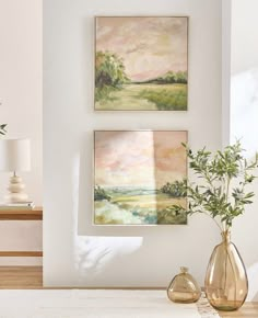 two paintings hang on the wall next to vases with plants in them and one is empty