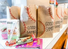 bags with good game candy are lined up on a counter top next to other snacks