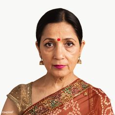 an older woman with dark hair wearing a red sari