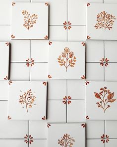 several tiles with different designs on them are arranged in the shape of flowers and leaves